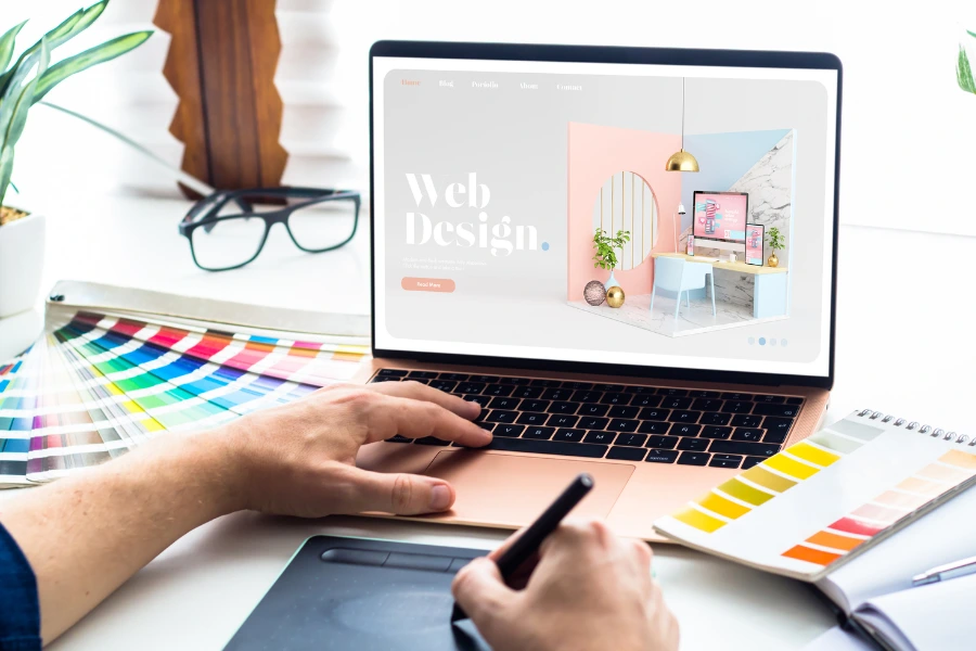 image of web designer with laptop and colour charts