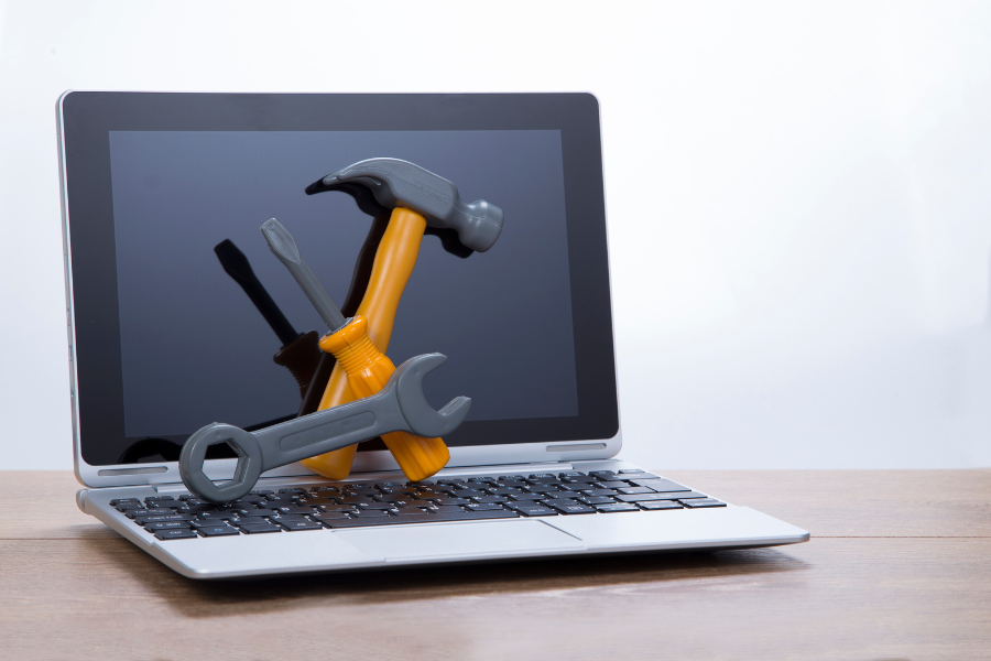 image of a laptop and tools for website maintenance