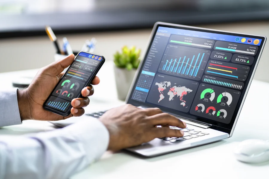 image of a laptop and phone showing the seo analytics dashboard in dark theme